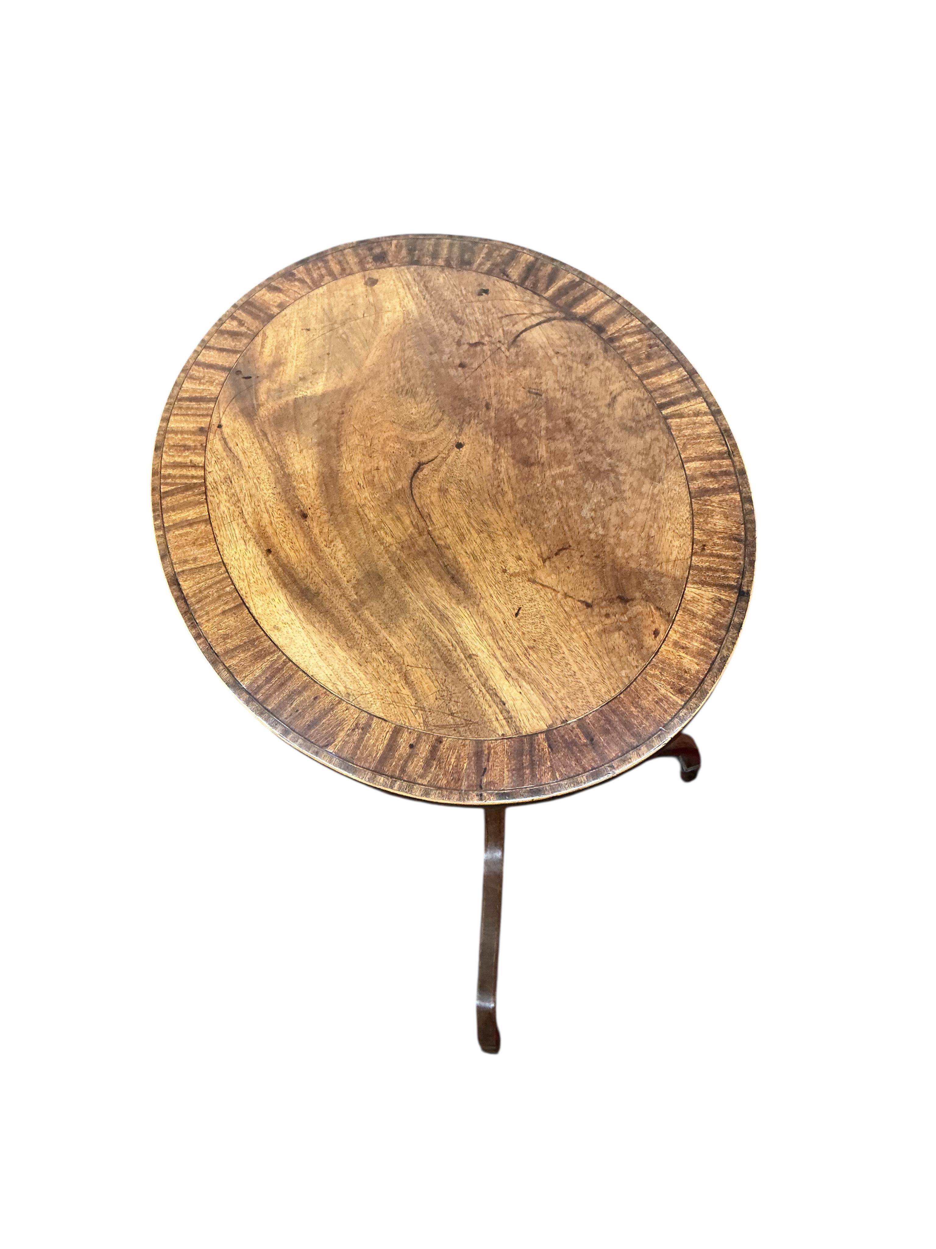 A George III banded mahogany oval tripod wine table, width 52cm, height 76cm